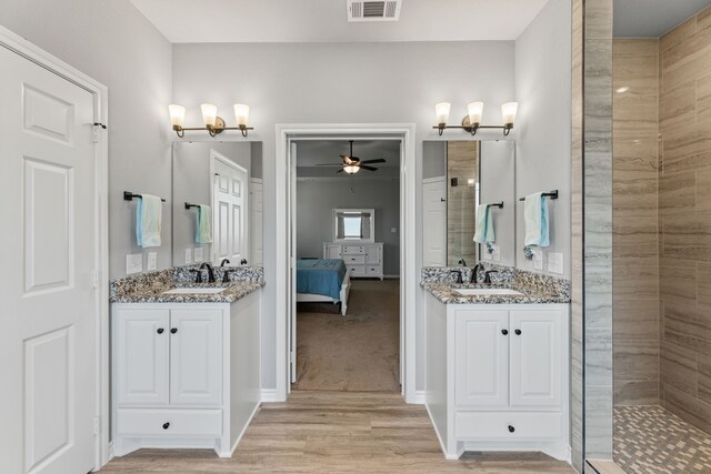 bathroom with vanity, hardwood / wood-style floors, and a shower with shower door