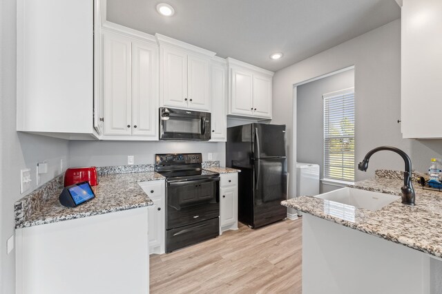 kitchen with dishwashing machine, light hardwood / wood-style flooring, white cabinetry, and light stone counters