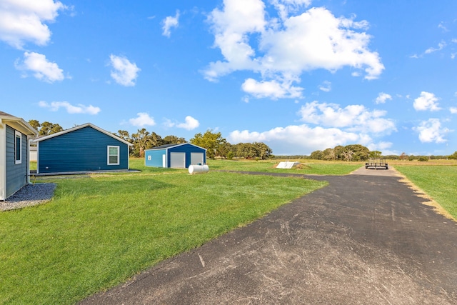 view of yard featuring an outbuilding and a garage