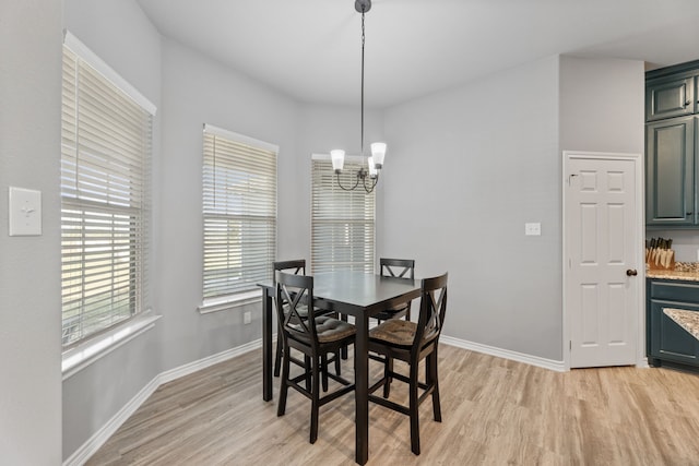 dining area featuring an inviting chandelier and light hardwood / wood-style flooring