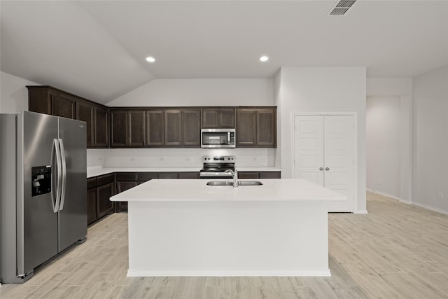 3476 N Crowley Cleburne Rd, Fort Worth, TX 76123 - kitchen with sink, a kitchen island with sink, light hardwood / wood-style floors, stainless steel appliances, and dark brown cabinets