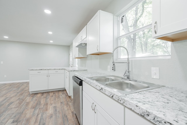 kitchen featuring light wood-type flooring, white cabinets, dishwasher, and sink