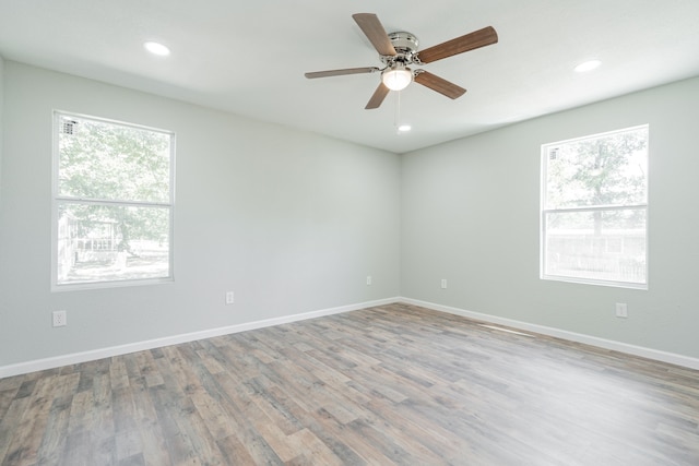 empty room featuring a wealth of natural light and ceiling fan