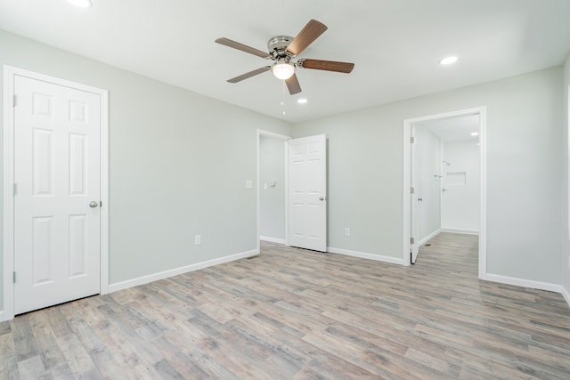 unfurnished bedroom with ceiling fan and light hardwood / wood-style floors