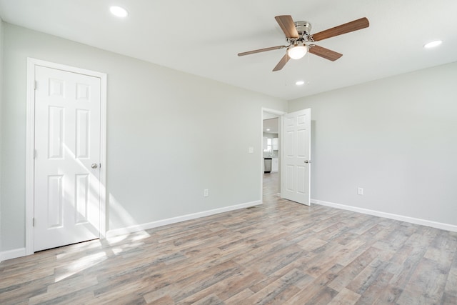 empty room featuring ceiling fan and light hardwood / wood-style floors