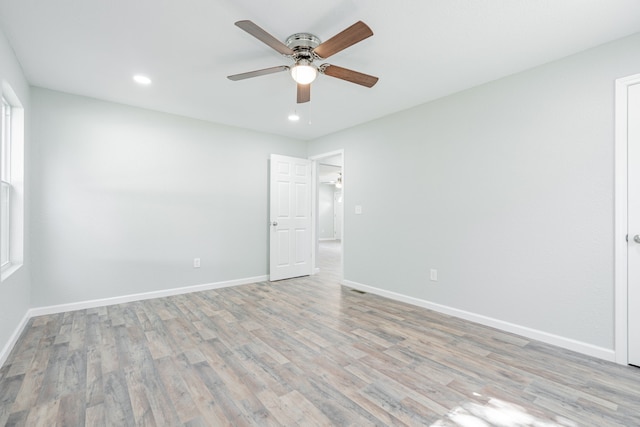 unfurnished room featuring light hardwood / wood-style flooring and ceiling fan