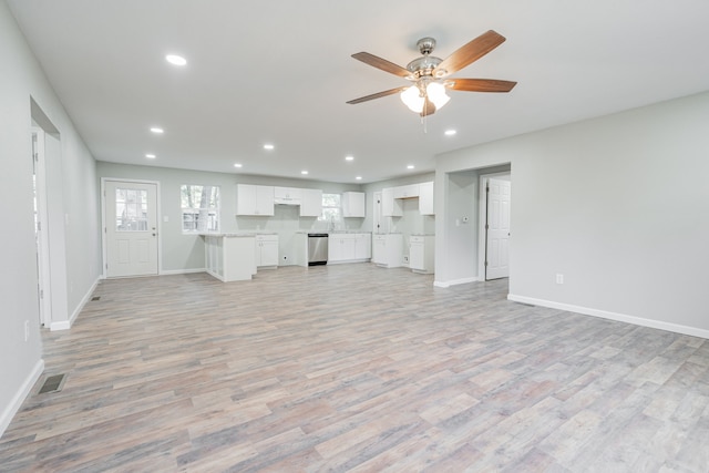 unfurnished living room featuring ceiling fan and light hardwood / wood-style floors