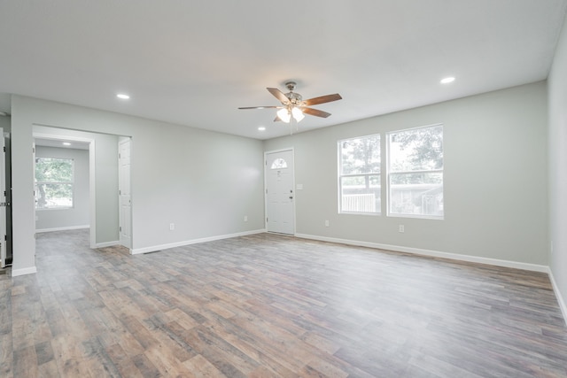 empty room with hardwood / wood-style flooring and ceiling fan