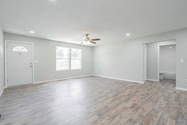 interior space with ceiling fan and hardwood / wood-style flooring