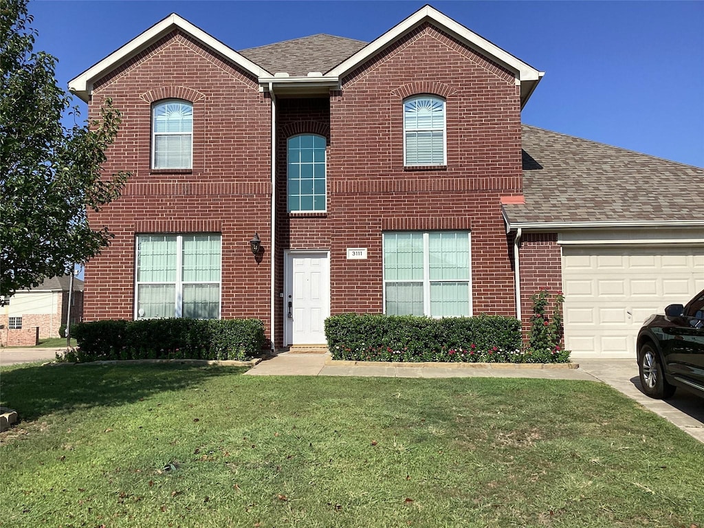 view of front of house with a garage and a front yard