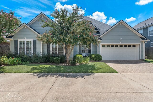 view of front of property featuring a front yard and a garage