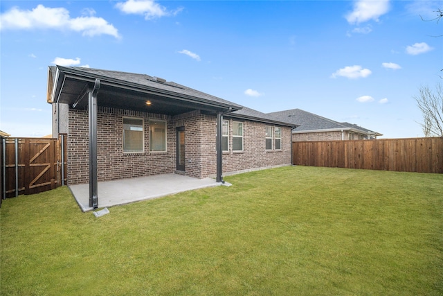 rear view of house with a patio area and a lawn