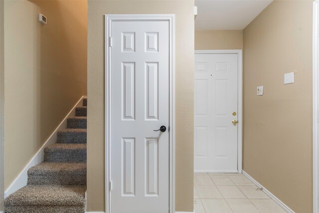 stairs with tile patterned floors