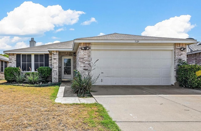 view of front of house with a front lawn and a garage