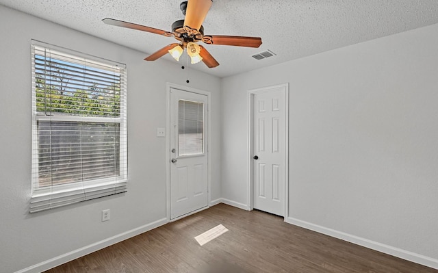 entrance foyer with ceiling fan, a textured ceiling, and wood-type flooring