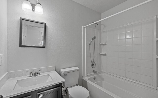 full bathroom featuring tiled shower / bath combo, toilet, and vanity