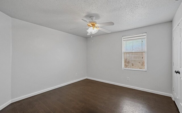 spare room featuring baseboards, a textured ceiling, dark wood-style flooring, and a ceiling fan
