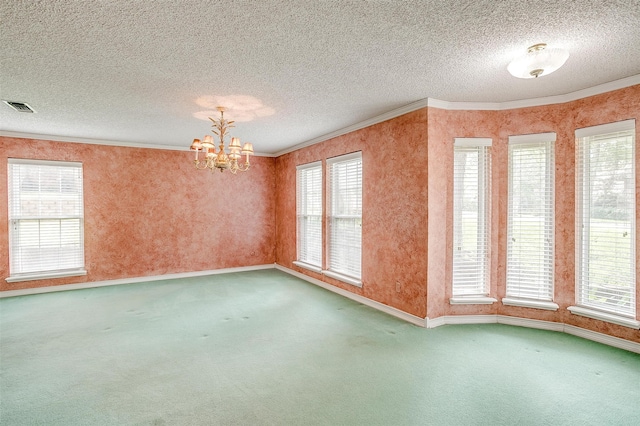 carpeted empty room with a textured ceiling, a chandelier, and plenty of natural light