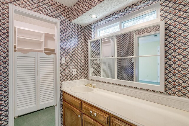 bathroom with a textured ceiling and vanity