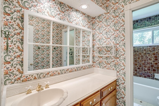 bathroom featuring a bath, vanity, and toilet