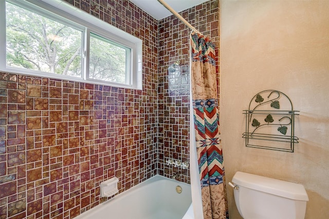 bathroom featuring shower / bath combo and toilet