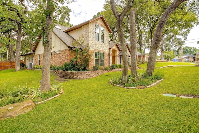 view of front of house with a front lawn and central air condition unit