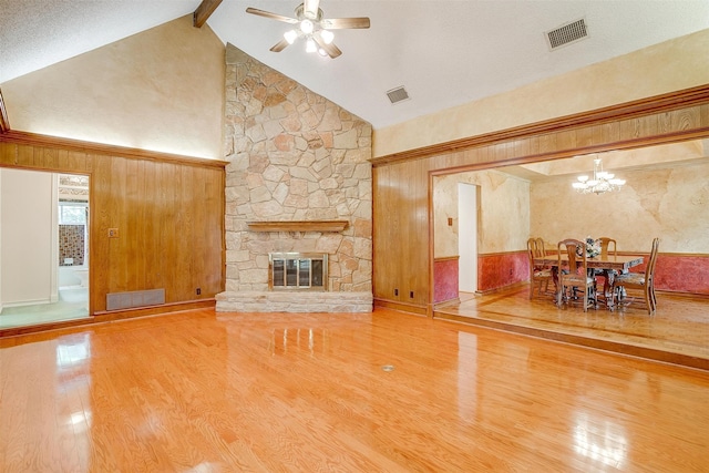 living room featuring high vaulted ceiling, wood-type flooring, beamed ceiling, and a fireplace