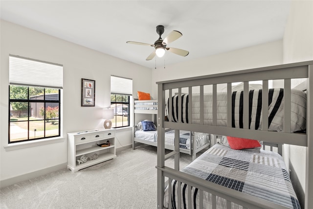 bedroom with ceiling fan and light colored carpet