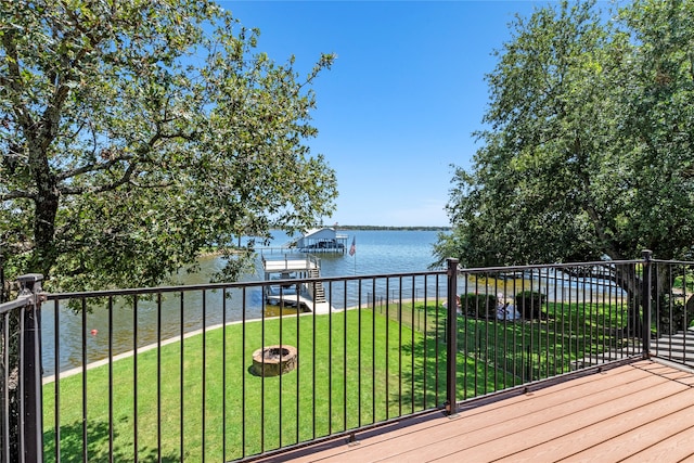 wooden terrace featuring a lawn and a water view