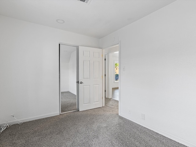 unfurnished bedroom featuring carpet floors and a closet