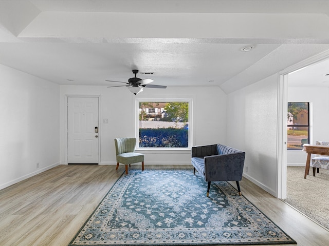 sitting room with ceiling fan, plenty of natural light, light hardwood / wood-style floors, and a textured ceiling