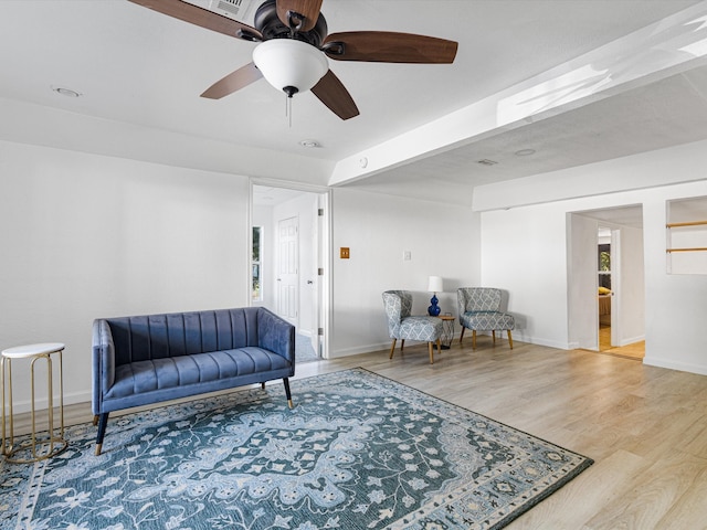 living area with hardwood / wood-style flooring and ceiling fan