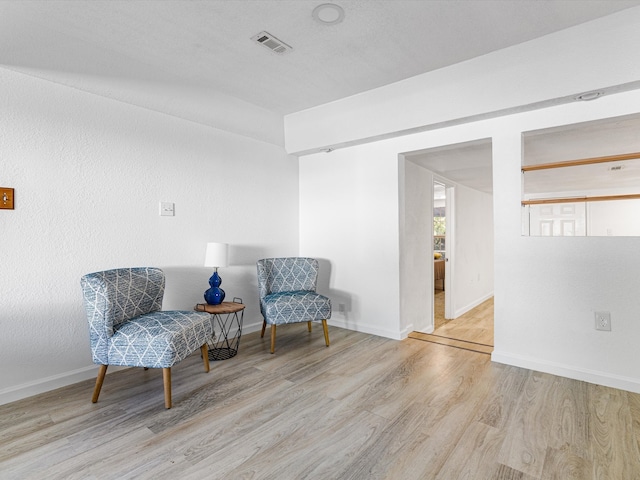 sitting room featuring light hardwood / wood-style floors