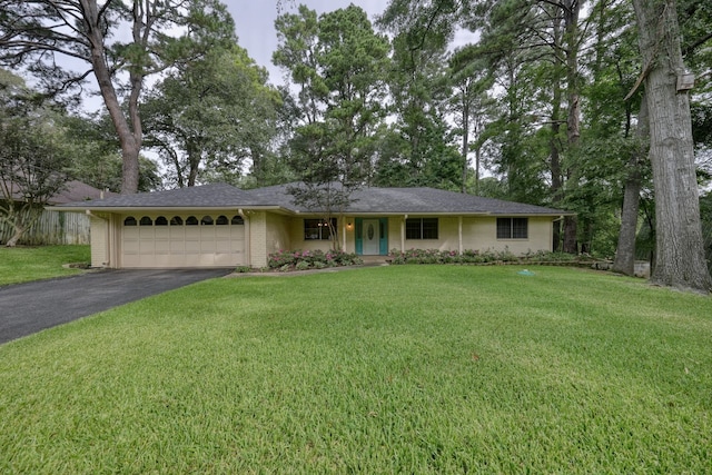 ranch-style house featuring a garage and a front lawn