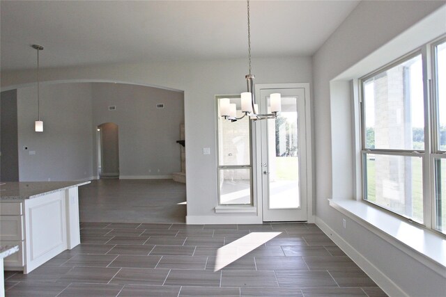 168 Falcon Point Dr, Heath, TX 75032 - unfurnished dining area with dark wood-type flooring, a chandelier, and plenty of natural light