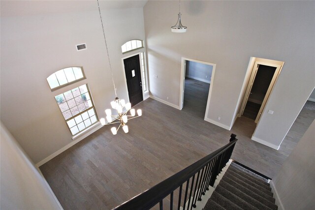 168 Falcon Point Dr, Heath, TX 75032 - entrance foyer with a notable chandelier, high vaulted ceiling, and dark hardwood / wood-style floors