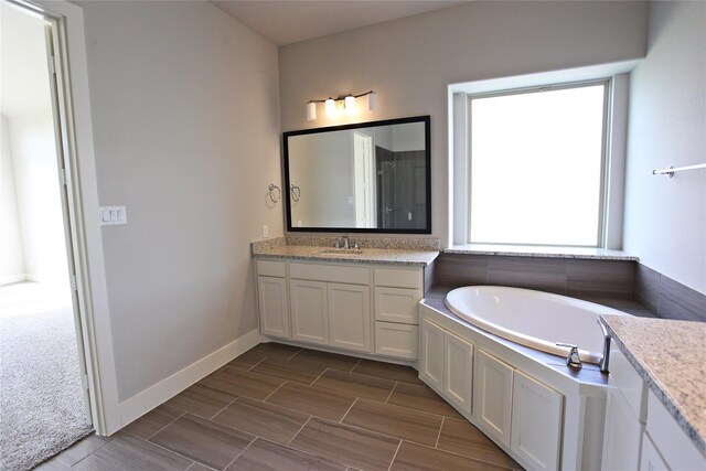 168 Falcon Point Dr, Heath, TX 75032 - bathroom featuring vanity, a bathtub, and a wealth of natural light