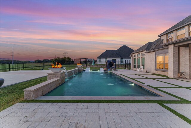 168 Falcon Point Dr, Heath, TX 75032 - pool at dusk with a yard, pool water feature, and a patio