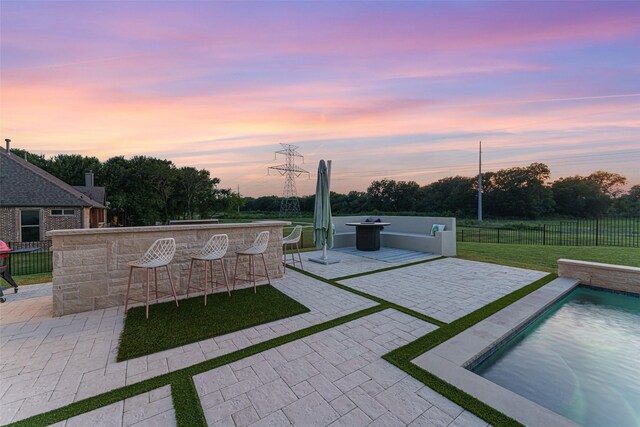 168 Falcon Point Dr, Heath, TX 75032 - patio terrace at dusk featuring a fenced in pool and exterior bar