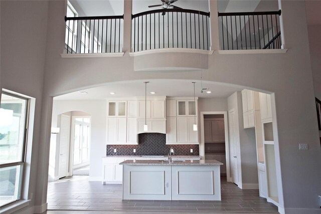 168 Falcon Point Dr, Heath, TX 75032 - kitchen with white cabinets, a center island with sink, and plenty of natural light