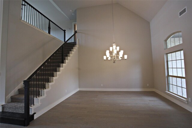 168 Falcon Point Dr, Heath, TX 75032 - stairway with a notable chandelier, wood-type flooring, and high vaulted ceiling