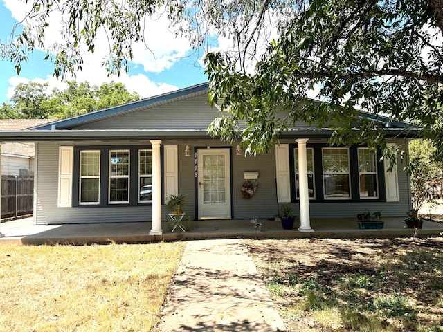 view of front of home with covered porch and fence