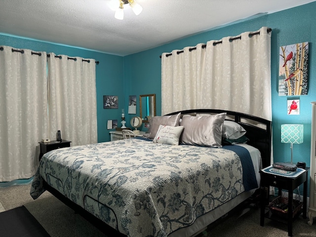 carpeted bedroom featuring a textured ceiling