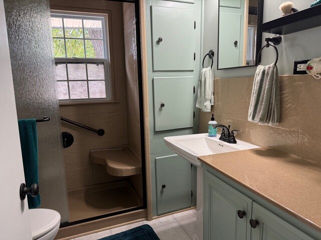 bathroom featuring a shower with door, backsplash, toilet, tile walls, and tile patterned floors