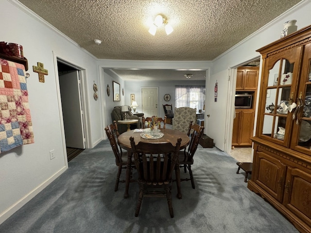 carpeted dining area featuring a textured ceiling and ornamental molding