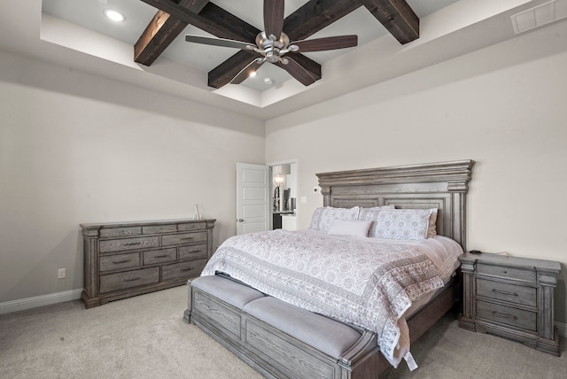 bedroom featuring ceiling fan, light carpet, and beam ceiling