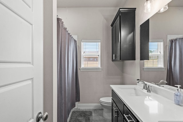 bathroom with tile patterned floors, vanity, and toilet