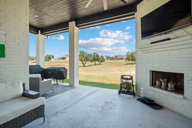 view of patio featuring an outdoor brick fireplace