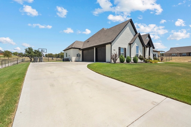 view of front of property featuring central AC unit, a garage, and a front yard