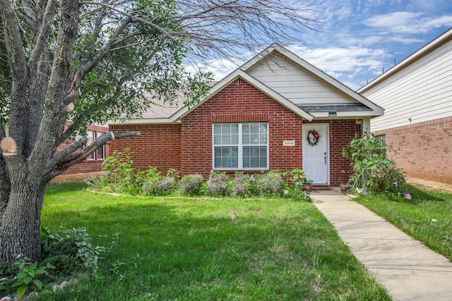 bungalow-style home featuring a front yard